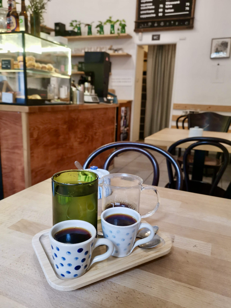 Two cups of coffee siting on a table at Mama Coffee in Prague