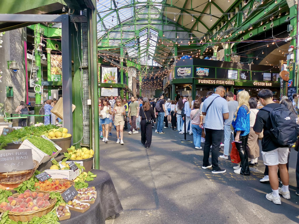 A group of people at borough market a good place to stop on a london itinerary