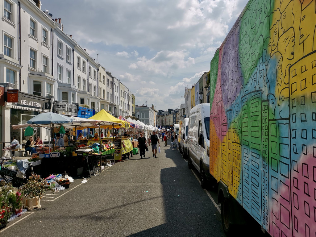 People walking down the portobello road market in Notting Hill, London