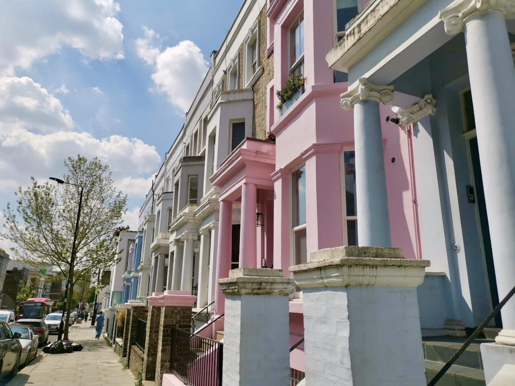 A row of colorful victorian terraced buildings in Notting Hill London