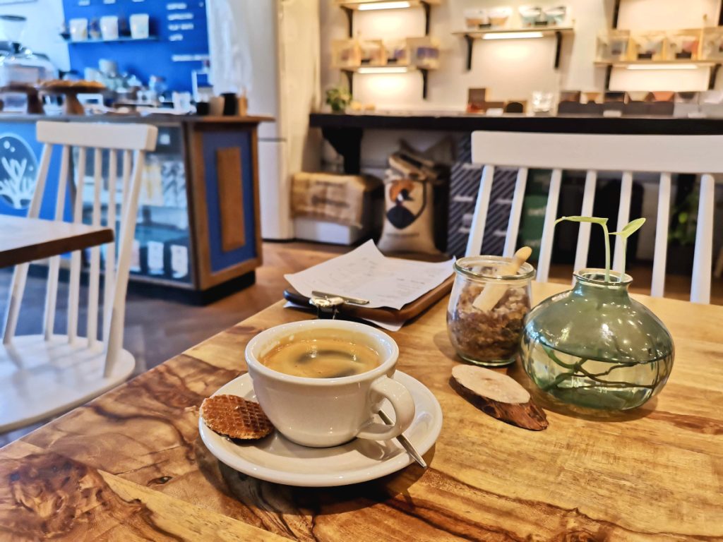 A cup of coffee sitting on a table in cafe sango one of the best cafes in amsterdam