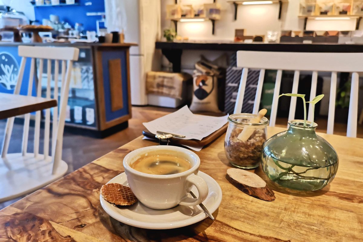 A cup of coffee sitting on a table in cafe sango one of the best cafes in amsterdam