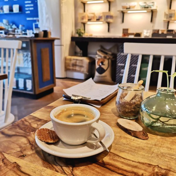 A cup of coffee sitting on a table in cafe sango one of the best cafes in amsterdam