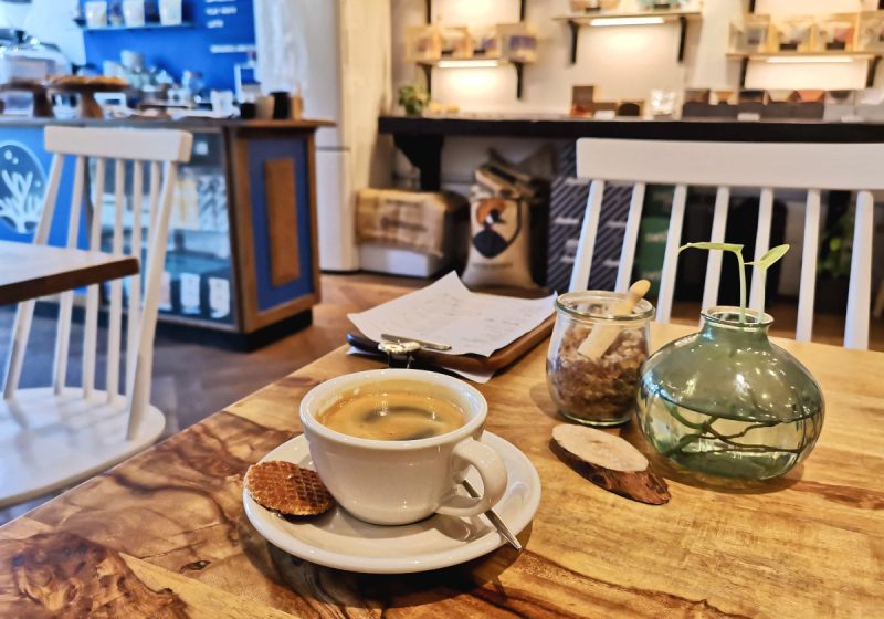 A cup of coffee sitting on a table in cafe sango one of the best cafes in amsterdam