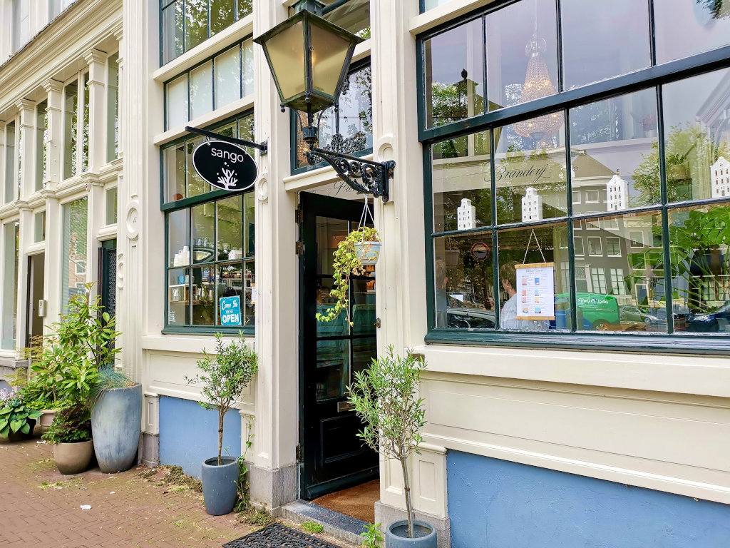 The entrance to sango cafe in an old historical building in amsterdam