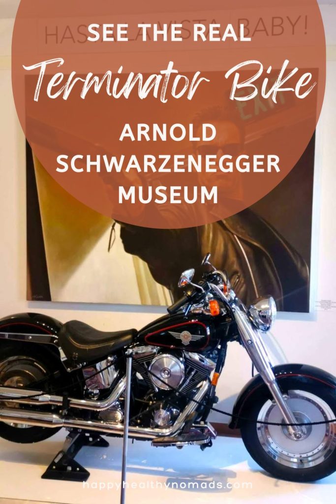 Terminator bike on a white podest with an text overlay saying "See the real Terminator Bike in the Arnold Schwarzenegger Museum".