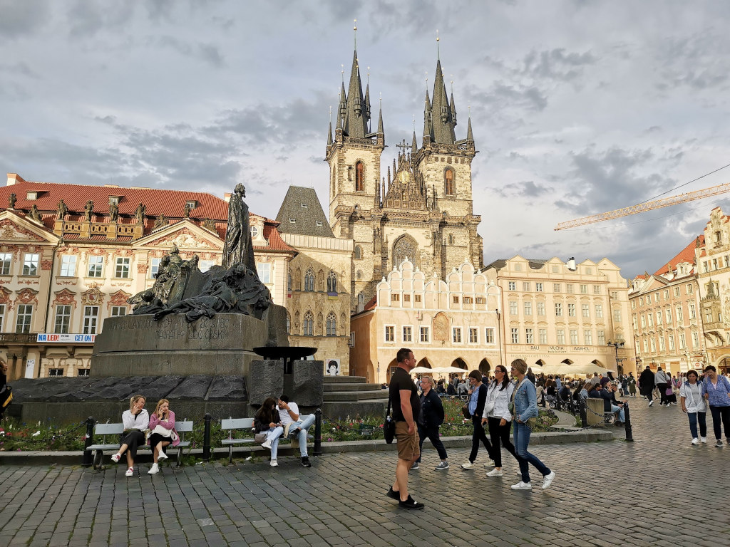 Tourists walking around in the prague old town amin square