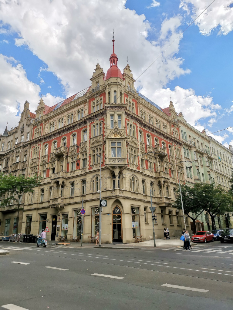 A beautiful old building on the corner of a street in prague