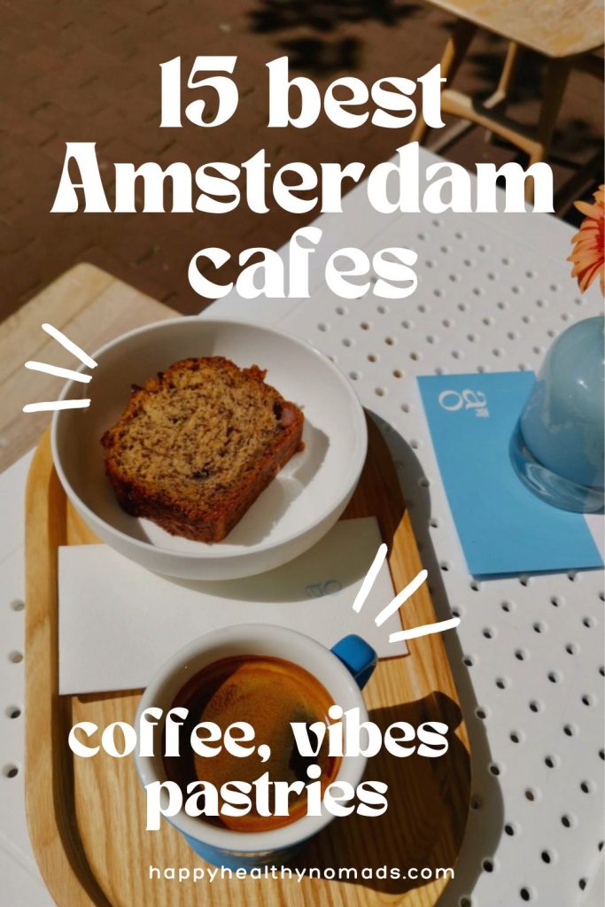 A black coffee next to a piece of banana bread on a wooden tray with a white text overlay saying "15 Best Amsterdam Cafes - Coffee, Vibes & Pastries".