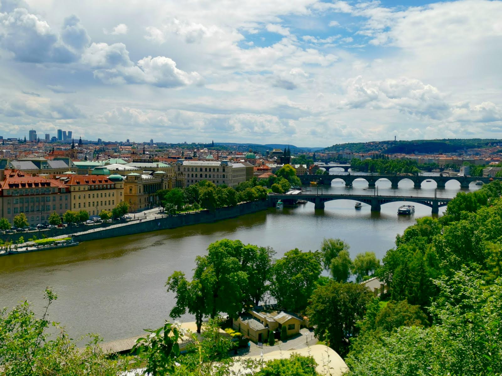 A view of three bridges on the Vltava River and the city of Prague from a hill top in Letná Park.