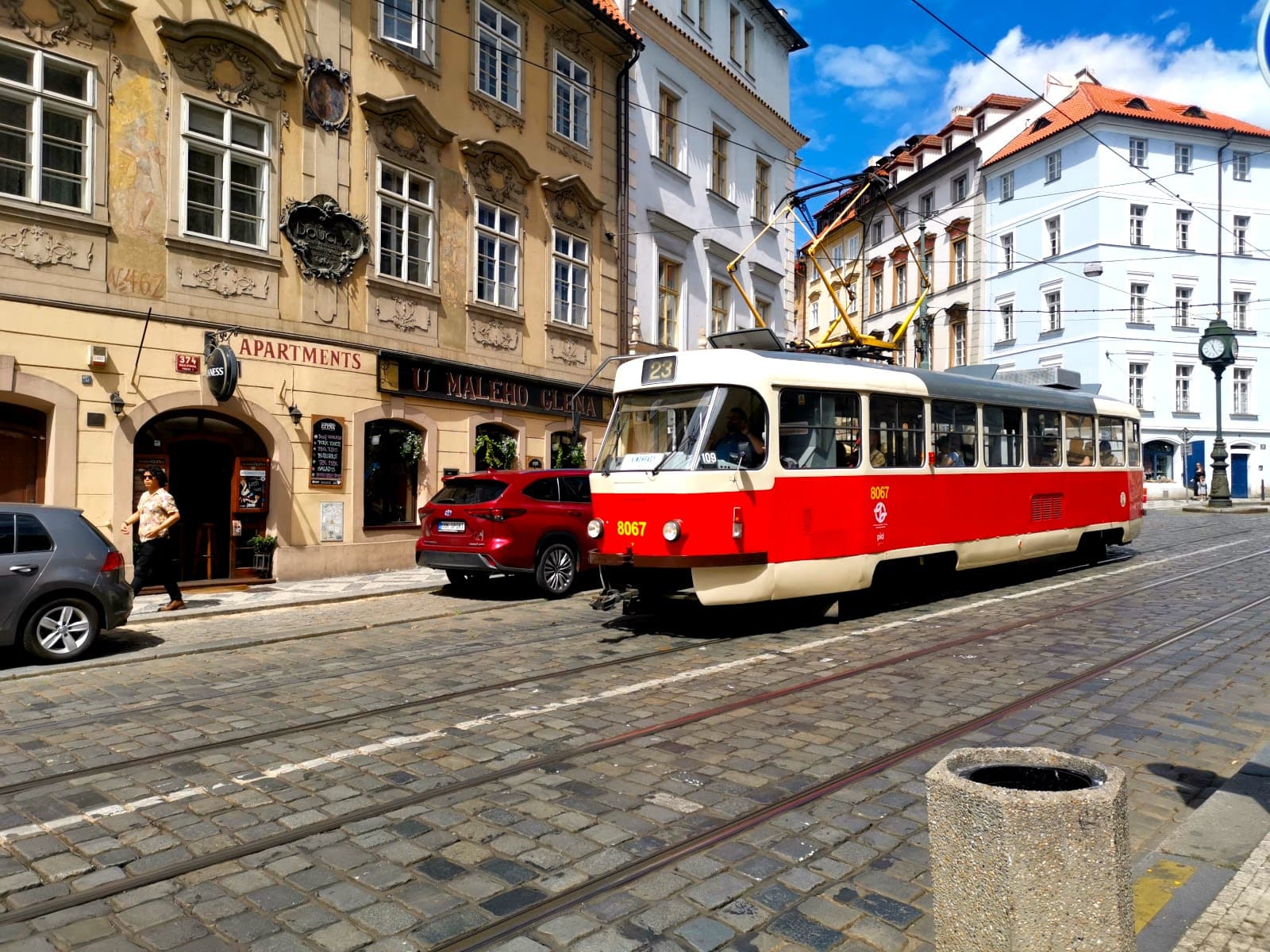 An old tram on a cobblestone street which is a great way to get around Prague.