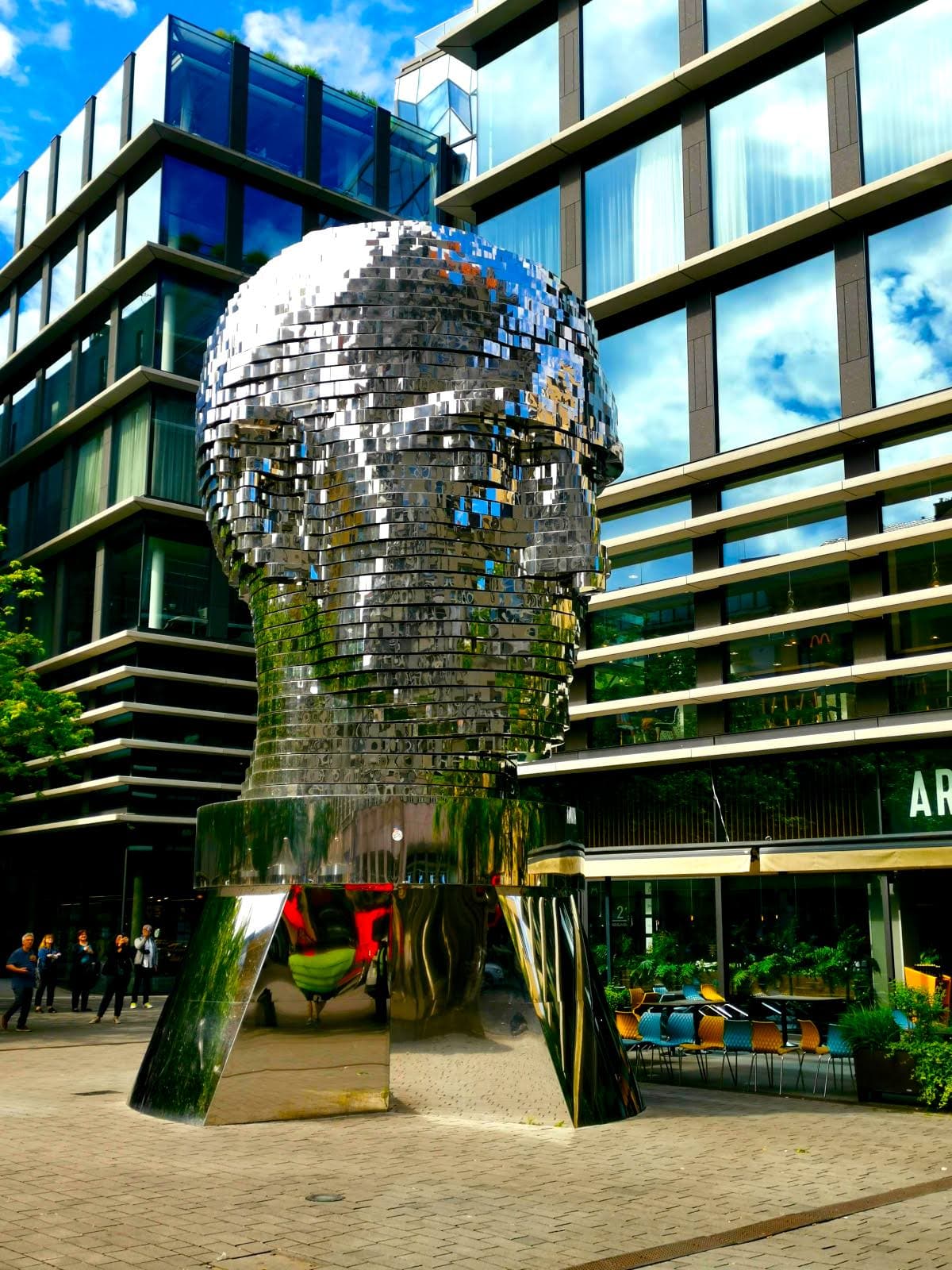 Rotating statue of Franz Kafkas head made of sparkling blocks that move in certain patterns every hour.