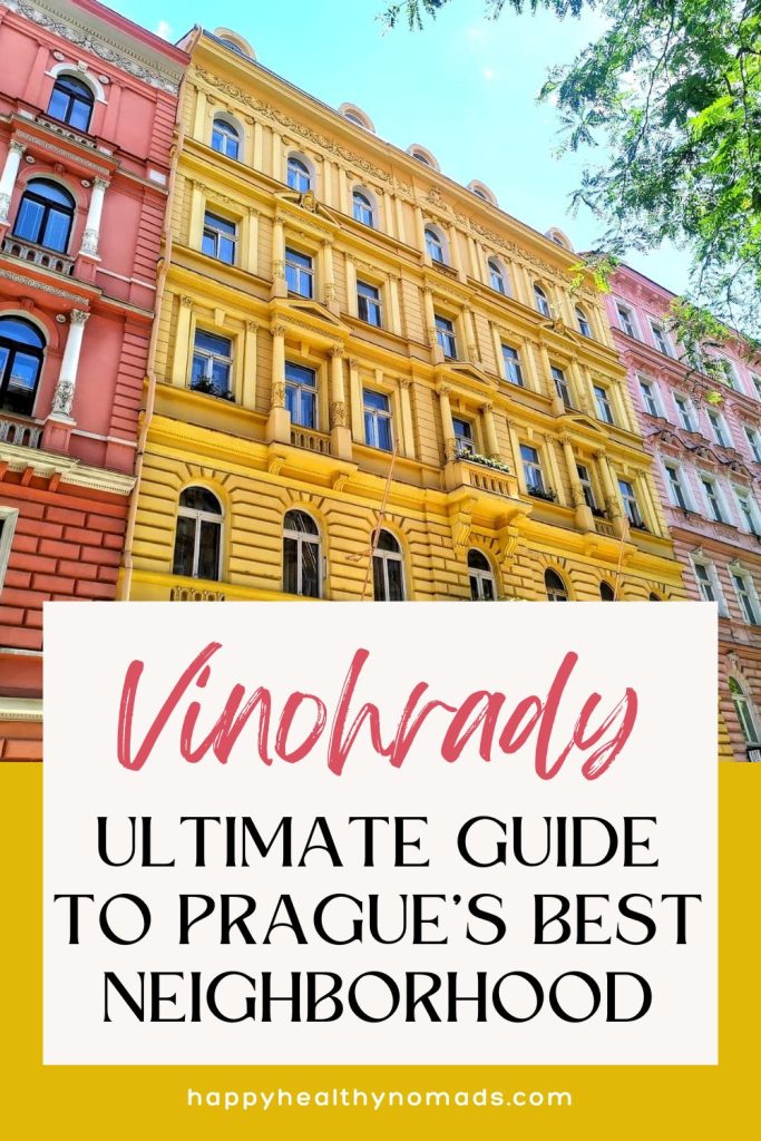 Line of colorful pink and yellow tall houses with a text overlay saying "Vinohrady: Ultimate Guide to Prague's Best Neighborhood".