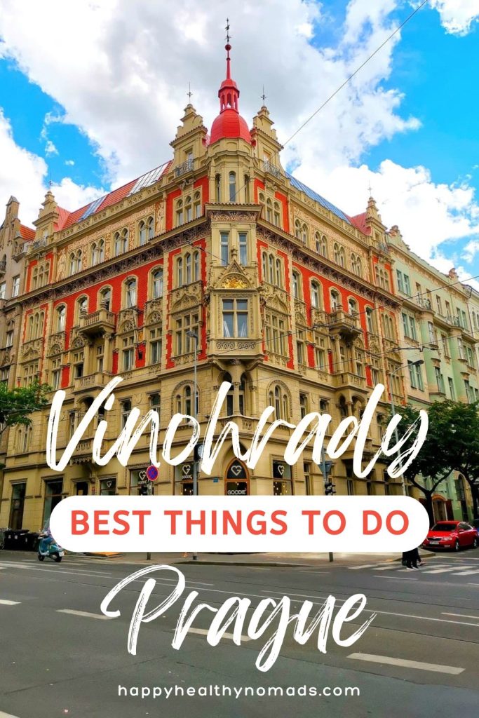 A colorful red and brown building with blue sky with a text overlay saying "Vinohrady: Best things to do in Prague".