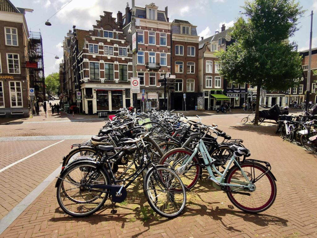 A collection of bikes on the street in Amsterdam