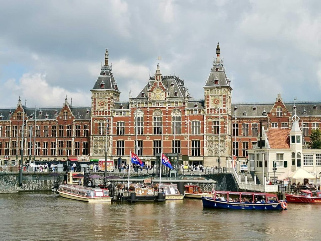 The Amsterdam Centraal station a large old brick building in the center of Amsterdam