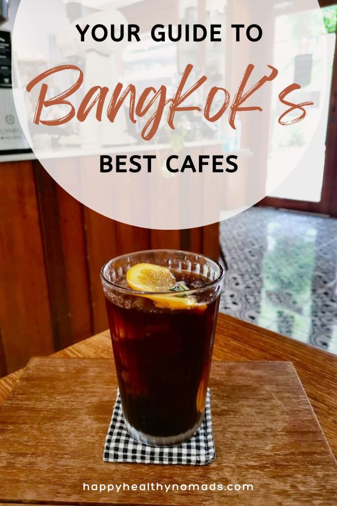 A refreshing orange-infused cold brew served on a wooden table in a cozy Bangkok cafe, featuring the title 'Your Guide to Bangkok's Best Cafes.' Ideal for cafe enthusiasts looking for unique coffee experiences in Bangkok.