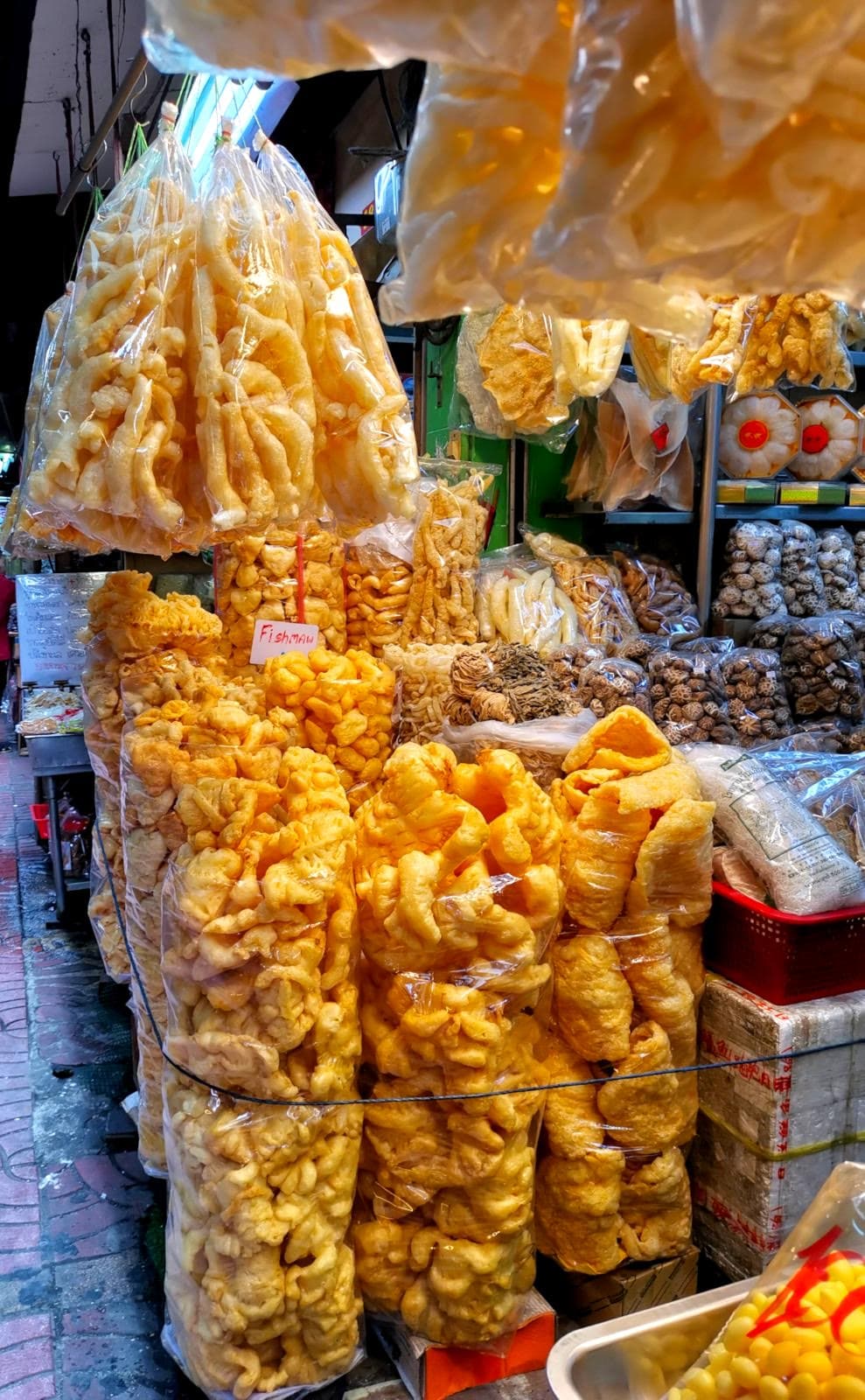 Dried yellow fish maw, which is the air bladder of a fish, for sale in transparent plastic bags in Chinatown, Bangkok.