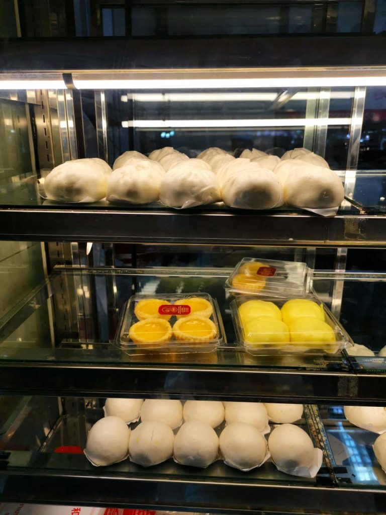 A warming oven filled with steamed buns and other baked goods of a food stall in Bangkok's Chinatown.