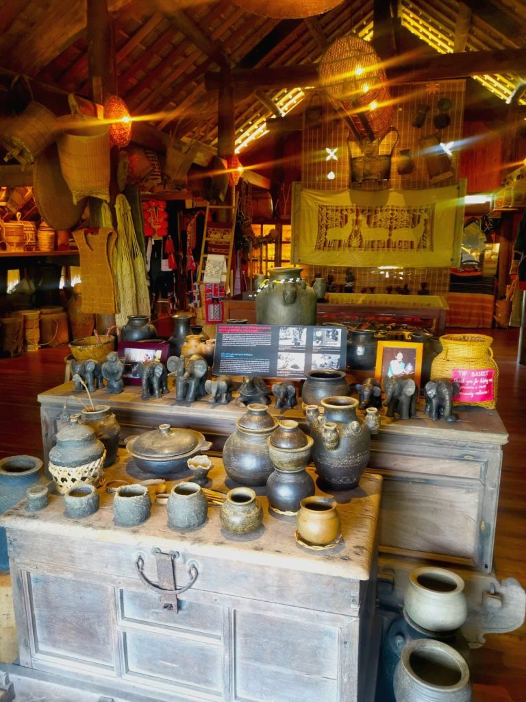 Two wooden tables with pottery at An Nhan Exquisite Cultural Gallery & Coffee Hoi An.