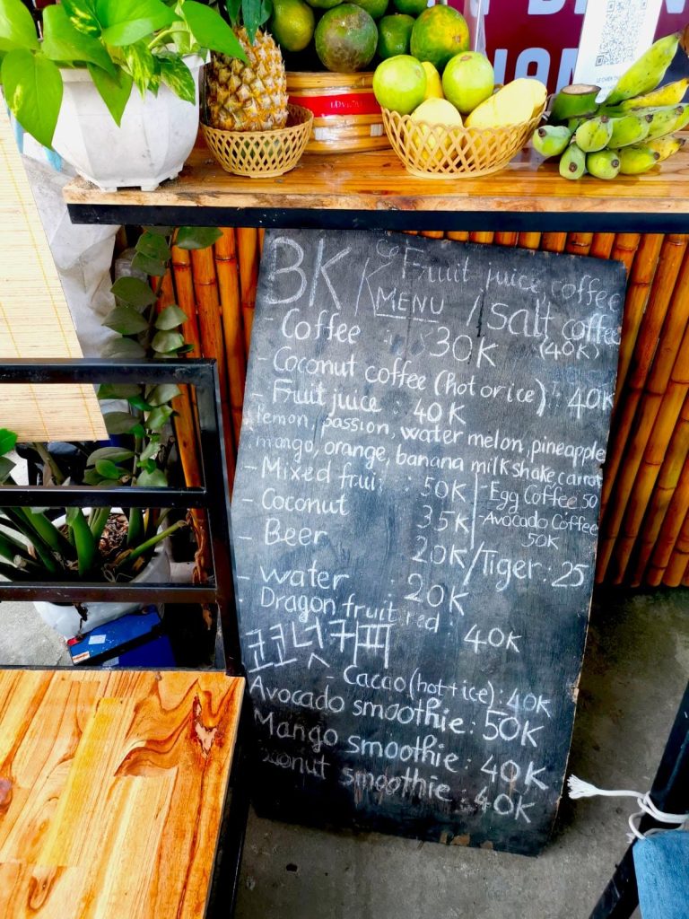 A Hoi An cafe menu in form of a black board advertising the different kinds of coffees and prices at BK Coffee at An Bang Beach.